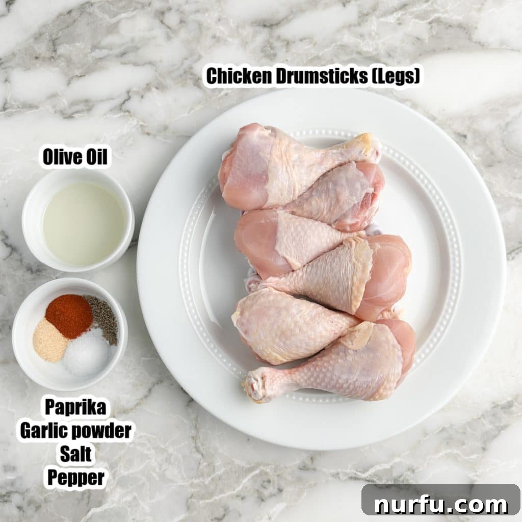 Baked Chicken Drumsticks: The Perfect Cooking Time 3 Collection of ingredients for baked chicken legs: plate of drumsticks, bowl of olive oil, and a small bowl of mixed spices.