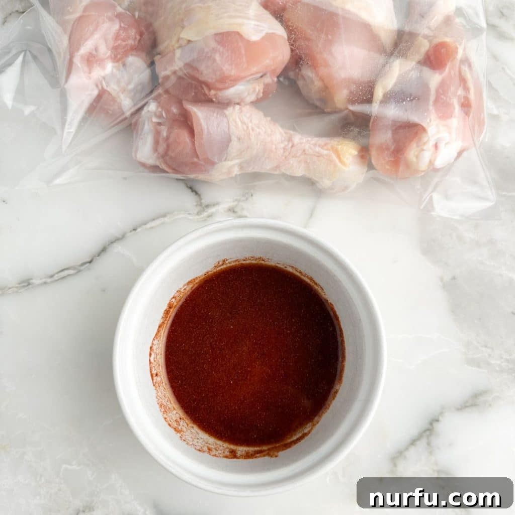 Baked Chicken Drumsticks: The Perfect Cooking Time 4 Chicken legs in a zip-top bag next to a bowl of mixed seasonings.