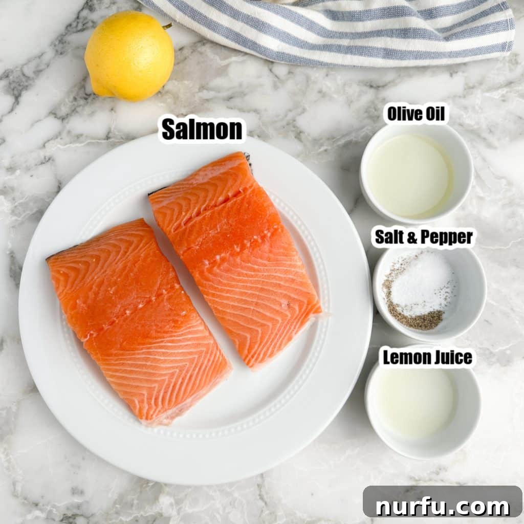 Plate with salmon, bowls with olive oil, seasonings, and lemon juice, illustrating the simple ingredients.