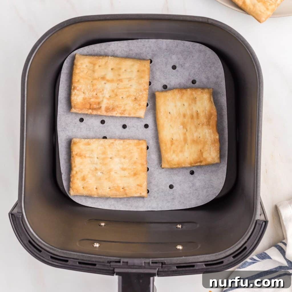 Perfect Air Fryer Toaster Strudel 4 Frozen toaster strudels neatly arranged in an air fryer basket, ready for cooking.