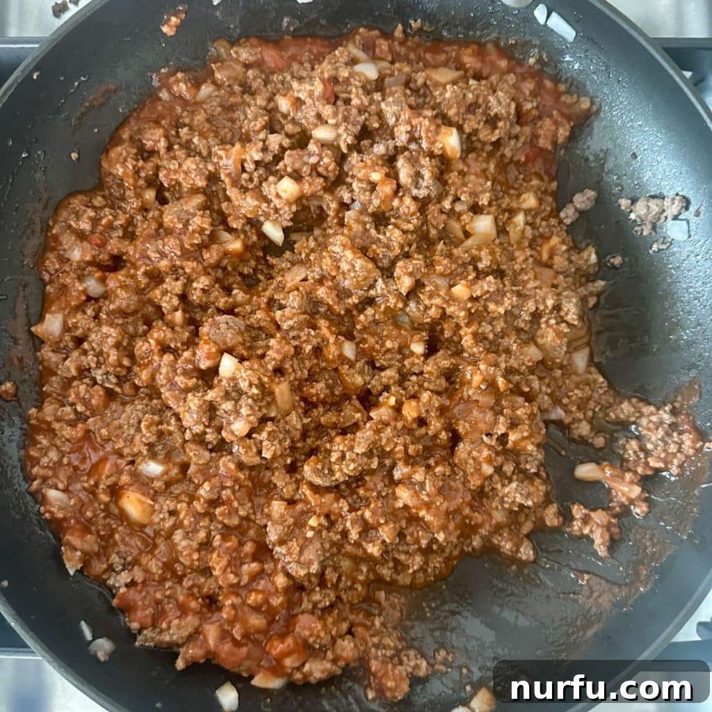 Ultimate Texas Toast Sloppy Joes 5 A close-up view of a skillet filled with the rich, simmering sloppy joe meat mixture, ready to be spread onto the Texas toast.