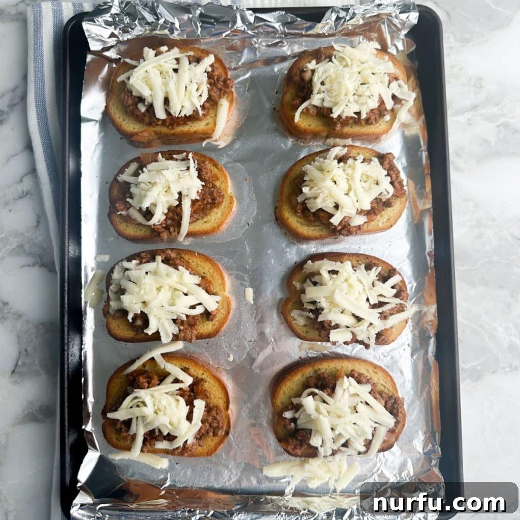 Ultimate Texas Toast Sloppy Joes 6 A baking pan showcasing perfectly assembled open-faced sloppy joe sandwiches, with toasted Texas toast, savory meat, and melted cheese, ready to be served.