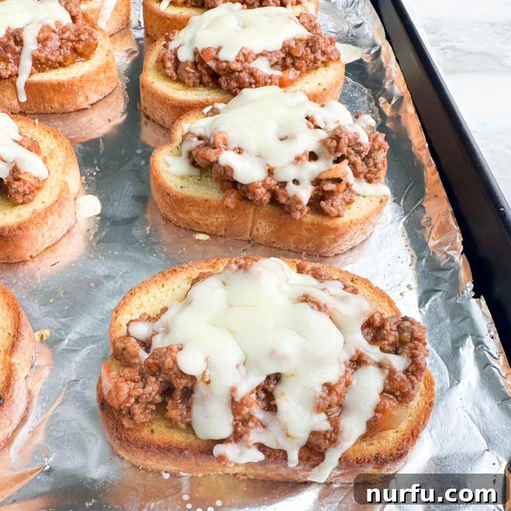 Ultimate Texas Toast Sloppy Joes 7 A baking pan filled with golden brown Texas Toast Sloppy Joes, showcasing the perfectly melted cheese and rich meat topping, ready to be served.