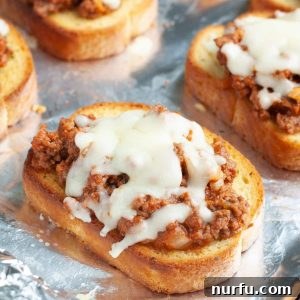 Piece of Texas Toast topped with sloppy joe meat and melted cheese.
