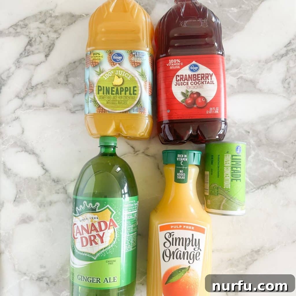 Vibrant Party Fruit Punch 3 Various bottles of juice and ginger ale, including pineapple, cranberry, and orange juice, laid out as ingredients for a fruit punch recipe.