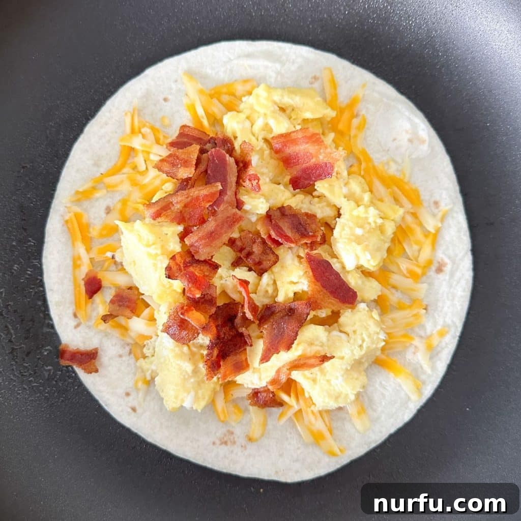Your Own Taco Bell Style Breakfast Quesadilla 4 Skillet with a quesadilla filling of cheese, eggs, and bacon.