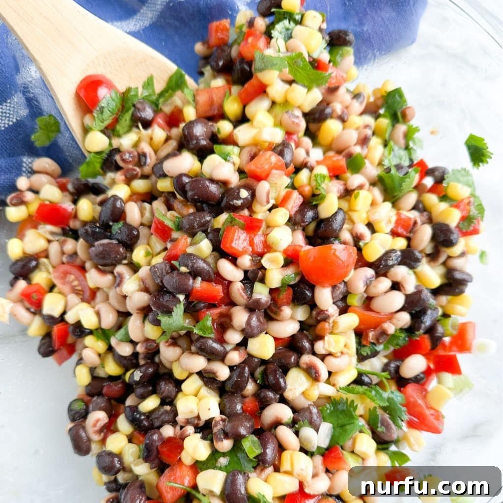 Lone Star Bean Fiesta 6 A beautifully presented bowl of Texas Caviar, showcasing the colorful blend of beans, corn, and peppers, ready to be enjoyed as a refreshing and healthy dish.