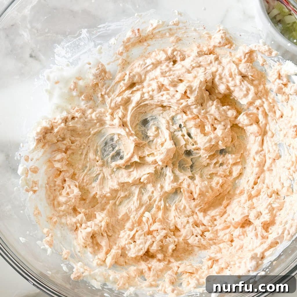Velvety Cream Cheese Corn Dip 4 Bowl of whipped cream cheese, mayonnaise, sour cream, and seasonings, forming the creamy base.
