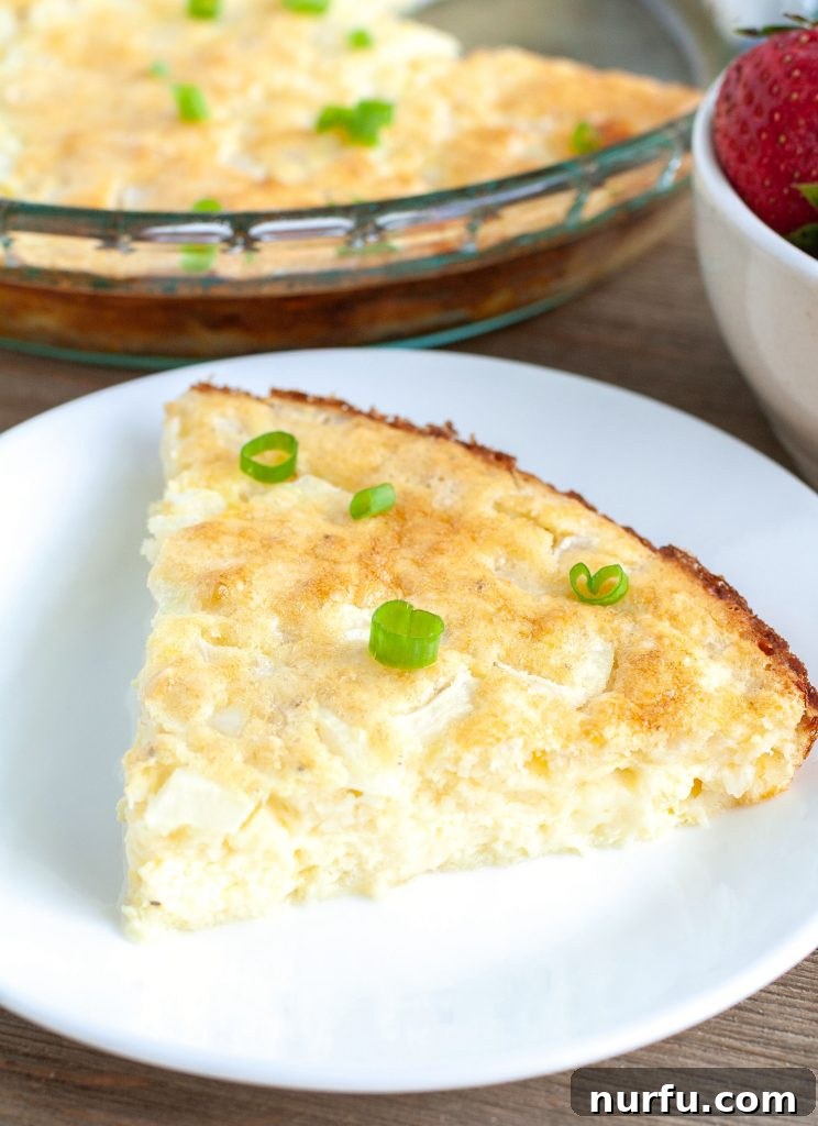 Slice of golden crustless quiche A perfectly baked slice of golden-brown crustless quiche, ready to be enjoyed.