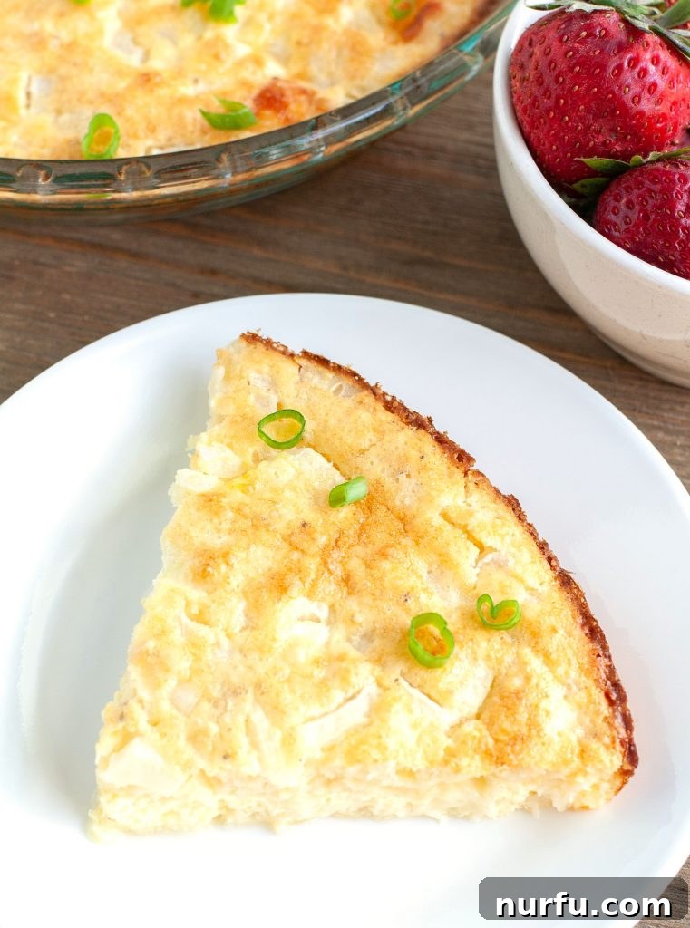 Slice of quiche with green onion A vibrant slice of crustless quiche garnished with fresh green onions on a white plate, ready to be eaten.