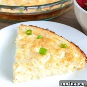Quiche with green onion on a plate.