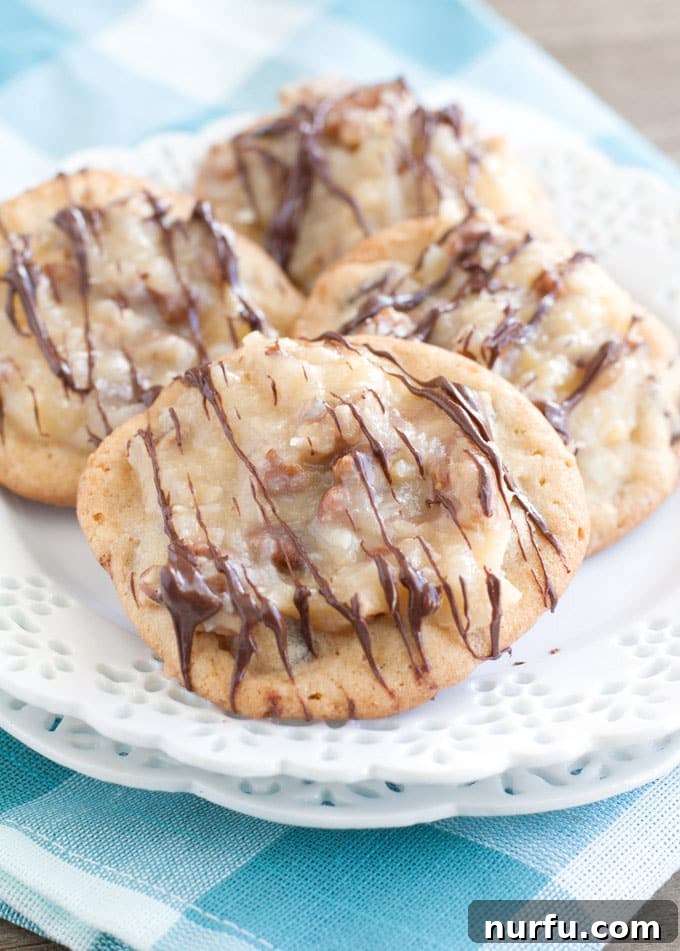 Delicious German Chocolate Chocolate Chip Cookies on a white plate, showcasing their rich chocolate base and creamy pecan-coconut frosting.