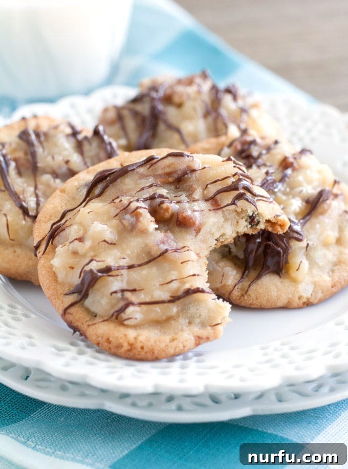 Platter of freshly baked German Chocolate Chocolate Chip Cookies, topped generously with pecan-coconut frosting and an optional chocolate drizzle.