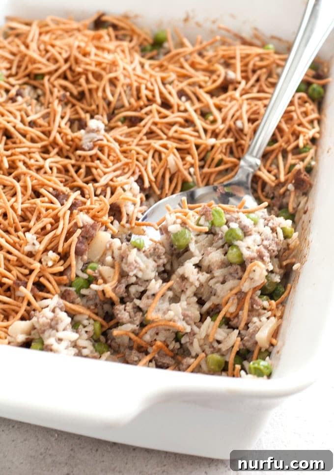 Asian Beef and Rice Casserole with serving spoon, ready to be dished out