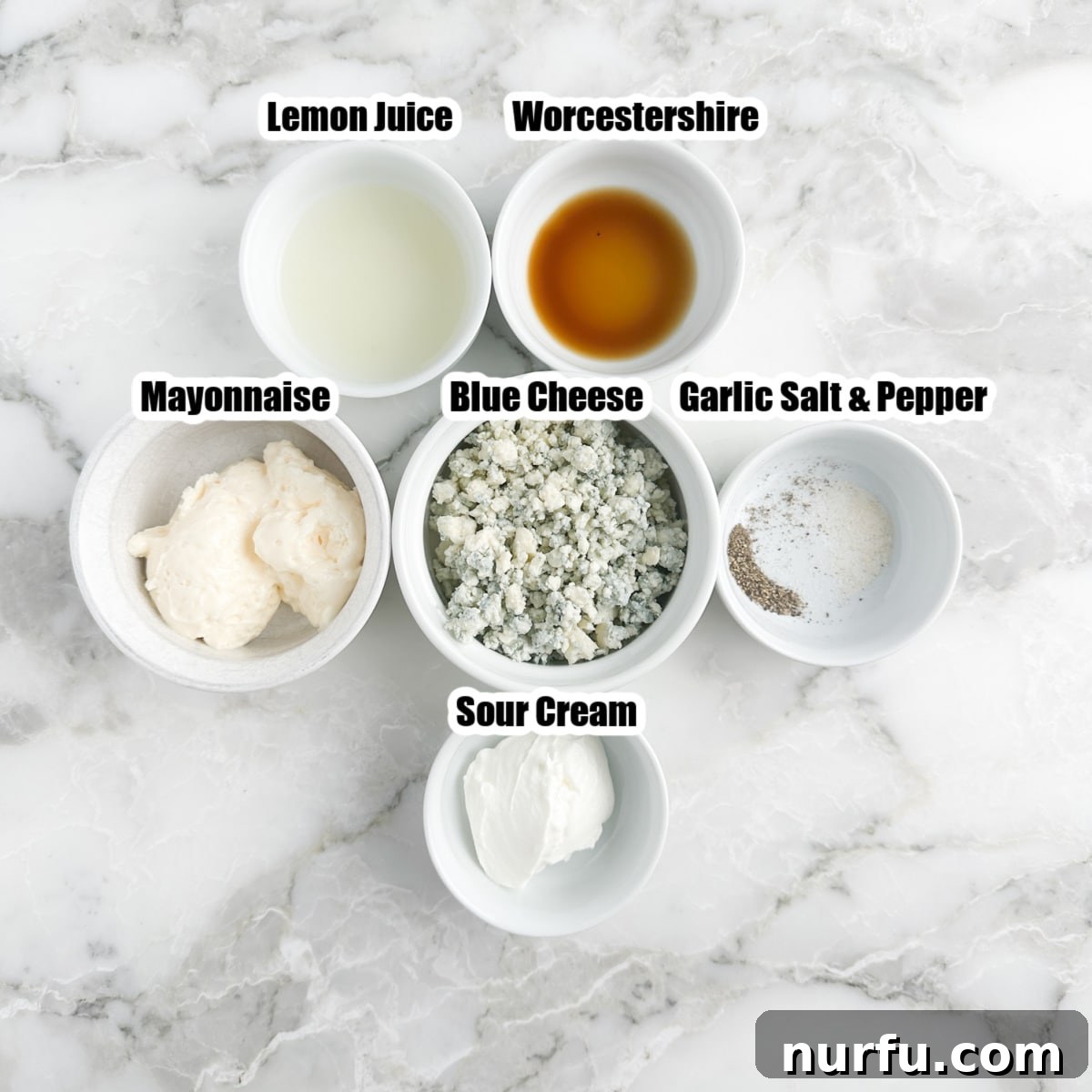Bowl of lemon juice, worcerstershire, mayo, blue cheese, and sour cream.