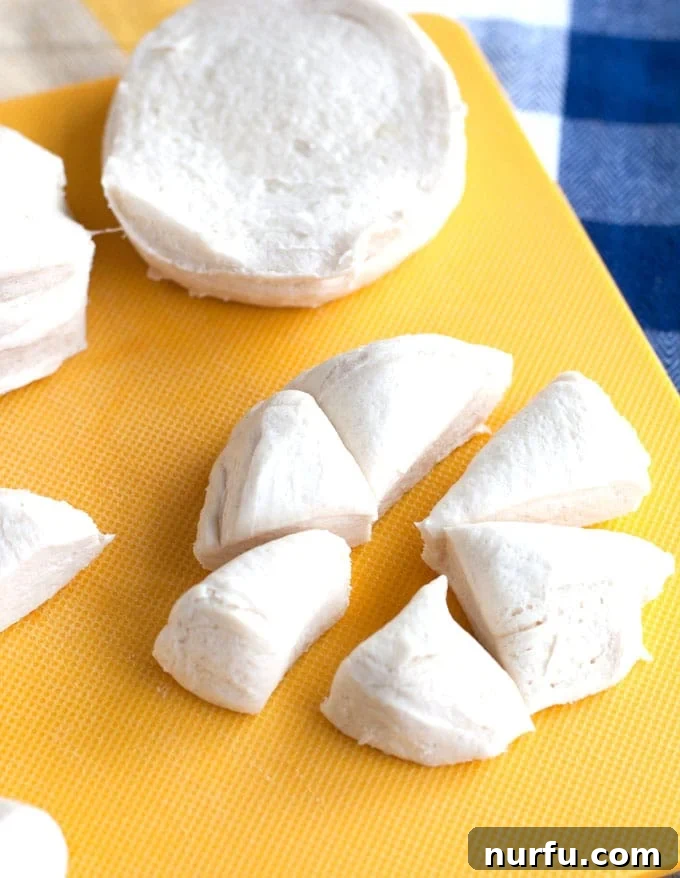 Sausage, Egg and Cheese Monkey Bread Biscuit dough cut into small, bite-sized pieces, ready for coating.