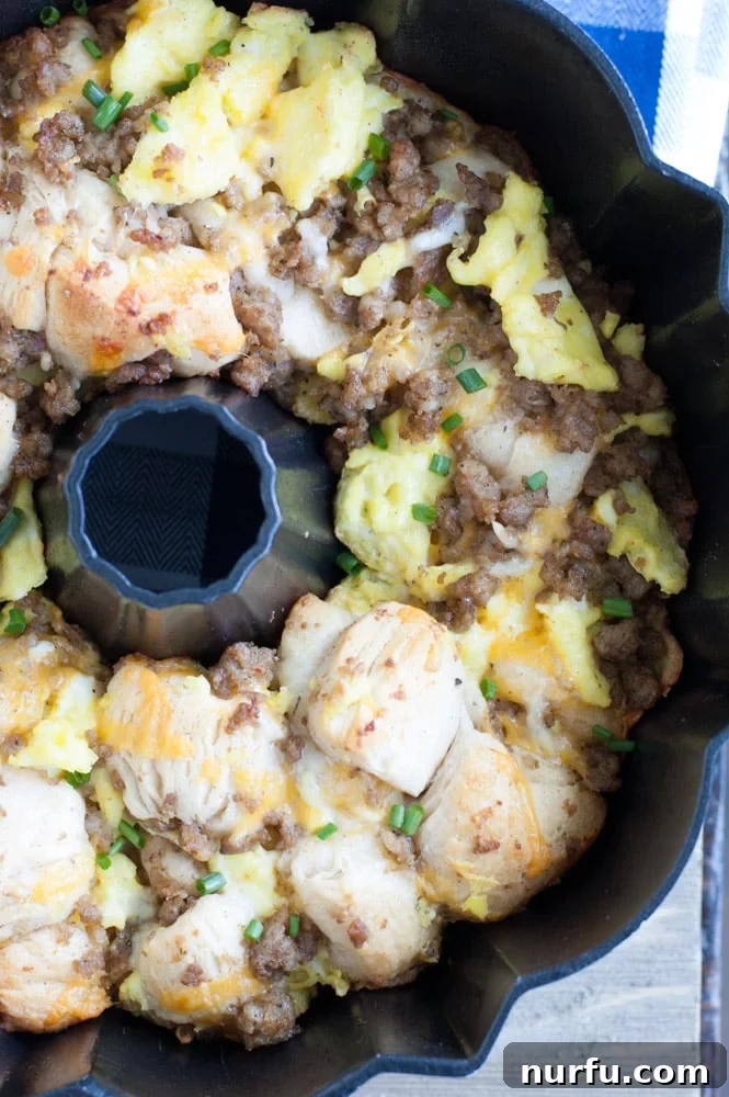 Sausage, Egg and Cheese Monkey Bread Sausage, Egg, and Cheese Monkey Bread baking in a bundt pan, turning golden brown.