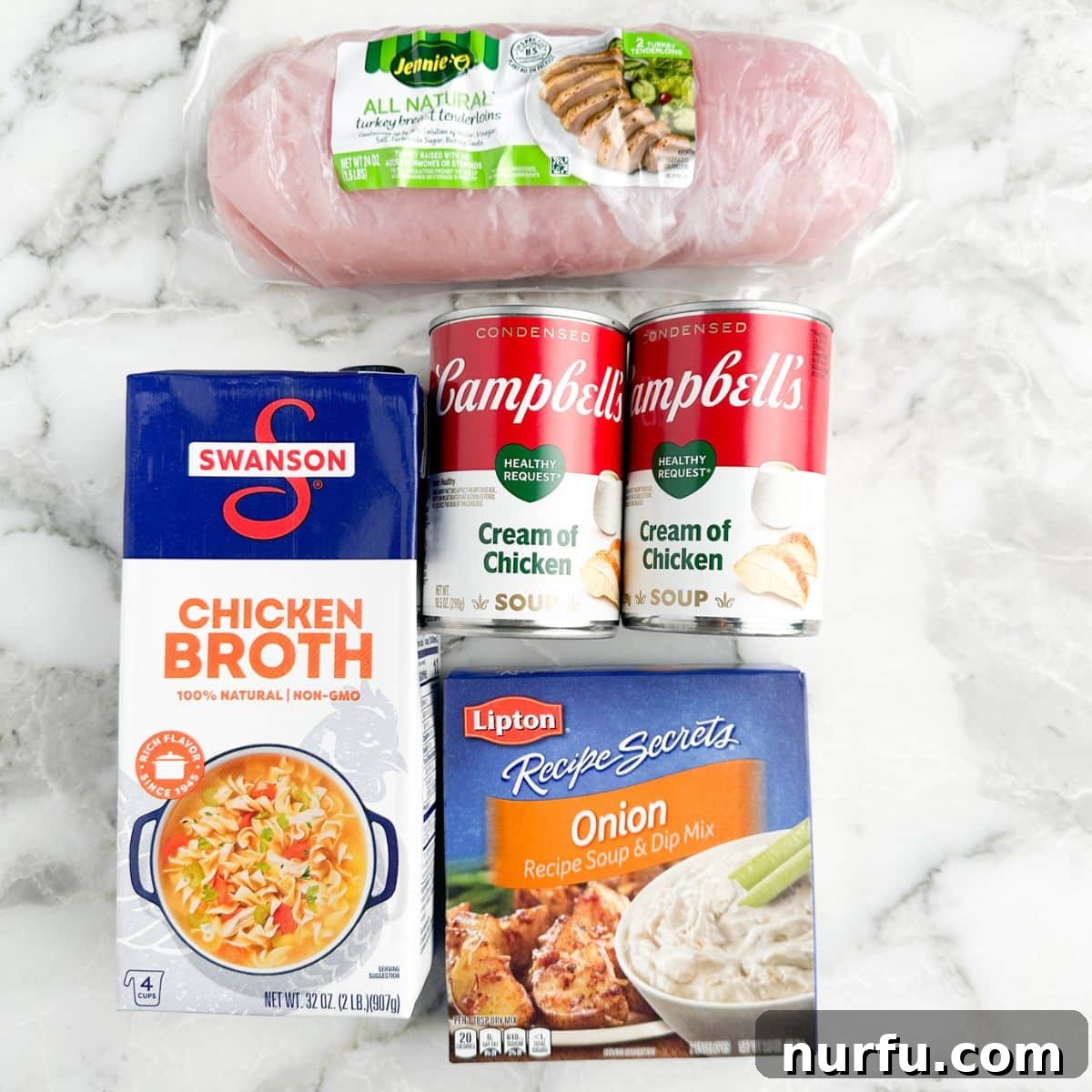 Collection of main ingredients for crockpot turkey tenderloins: a box of chicken broth, two cans of cream of chicken soup, a package of turkey tenderloins, and an envelope of onion soup mix.