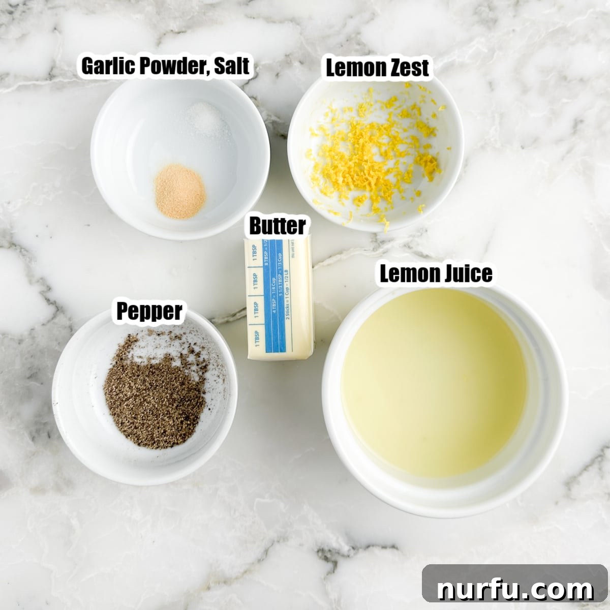 Zesty Lemon Pepper Sauce 3 Individual ingredients for lemon pepper sauce laid out: a bowl of black pepper, fresh lemon zest, fresh lemon juice in a measuring cup, and a stick of butter, highlighting the simplicity of the recipe.