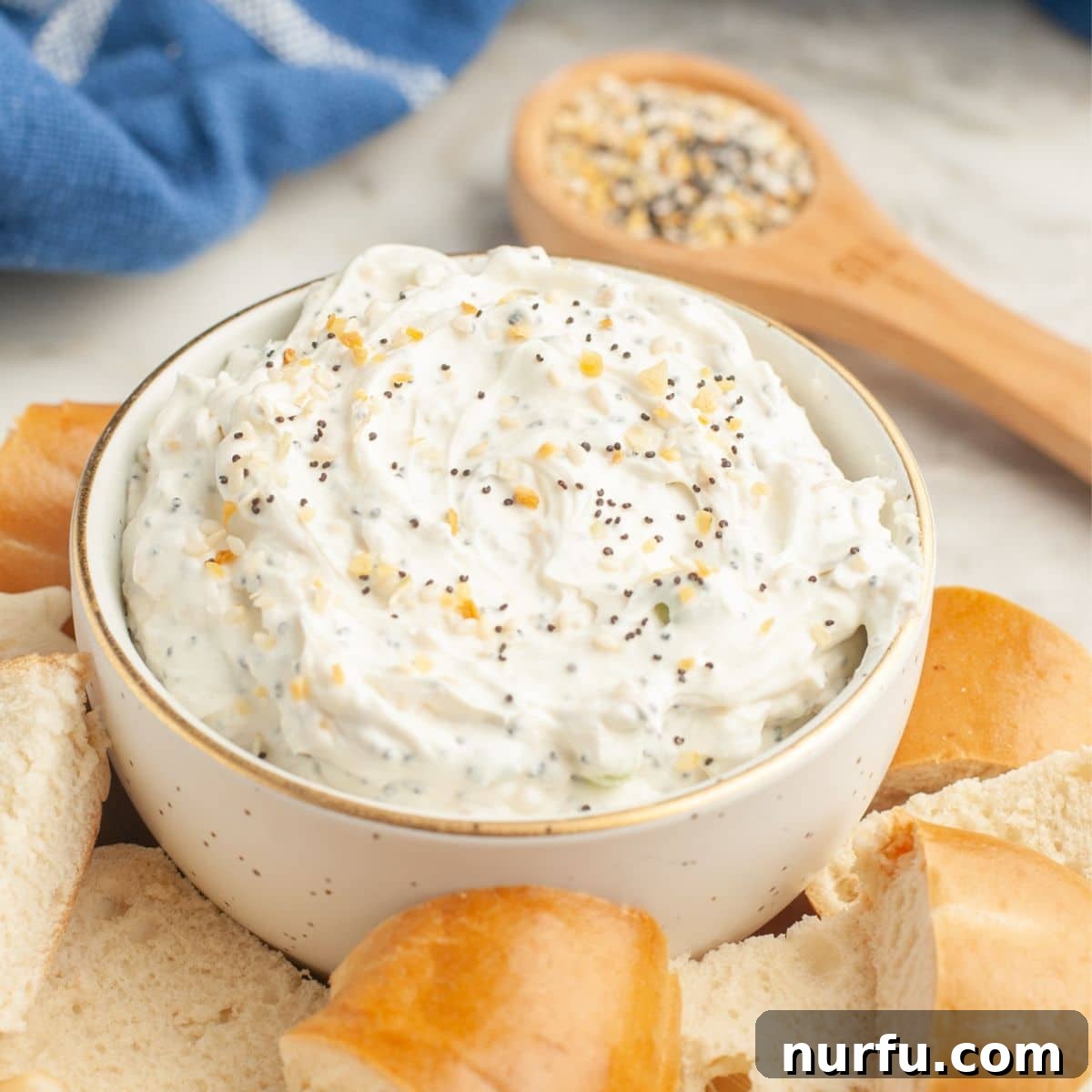 Quick & Creamy Bagel Dip 2 Bowl of everything bagel cream cheese dip with cut up bagels, ready to be served.