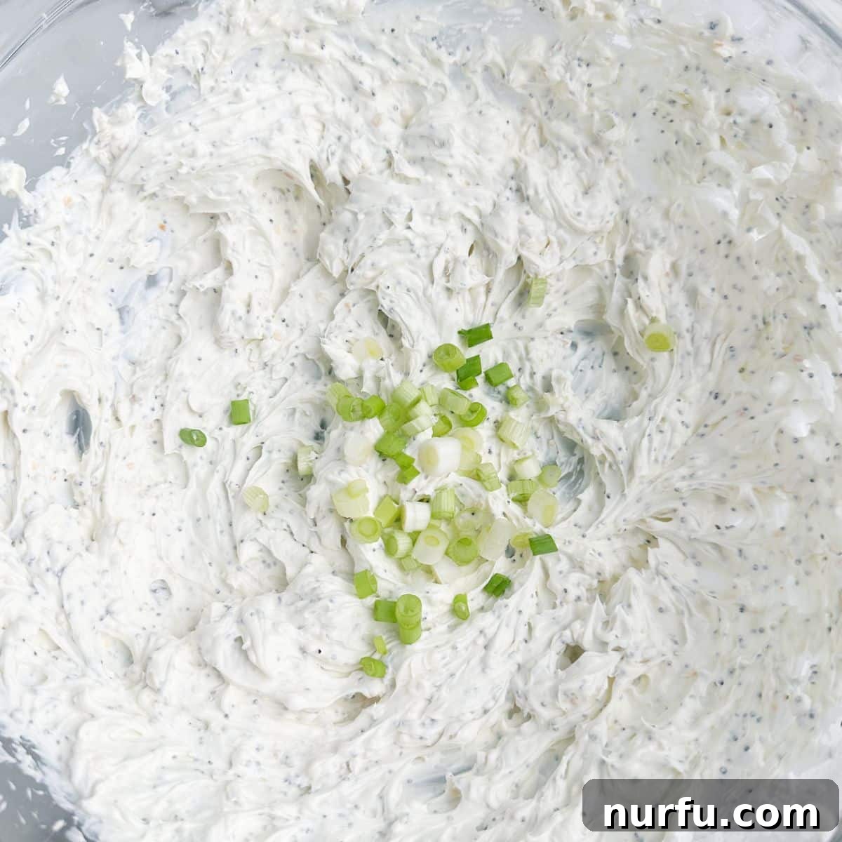 Quick & Creamy Bagel Dip 6 Bowl with whipped cream cheese and diced green onion stirred in, ready to serve.