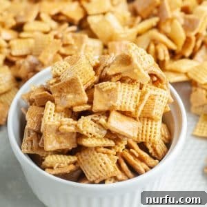 A close-up shot of a bowl brimming with the delicious Sweet Chex Mix, highlighting its glazed texture and inviting appearance.