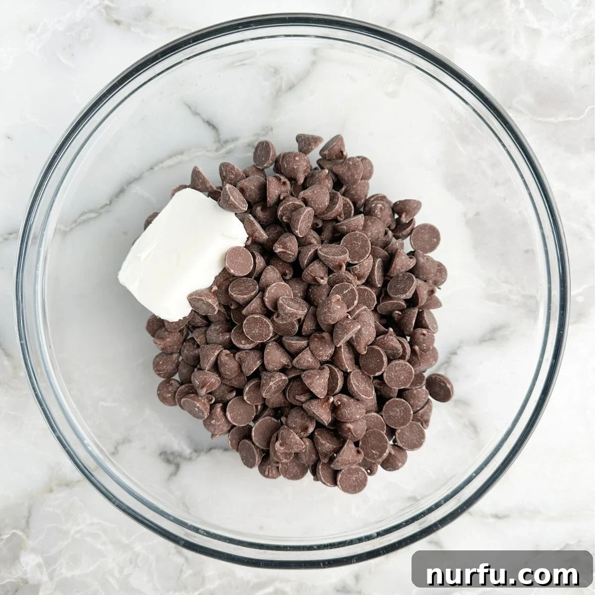 Sweet Salty Chocolate Chip Perfection 4 A bowl containing rich, melted chocolate chips and shortening, ready for dipping.