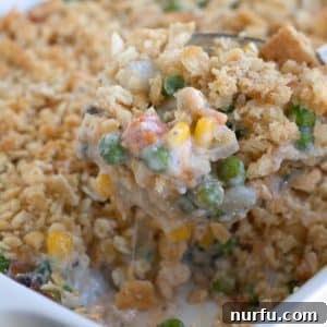 Casserole dish with golden-brown cheesy vegetable casserole.