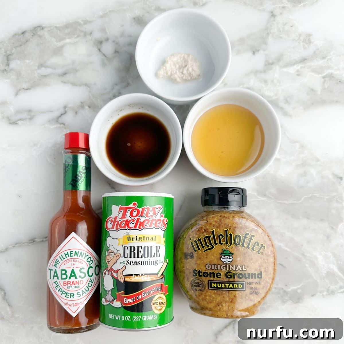 Craft Your Own Creole Mustard 3 Separate bowls containing honey, prepared horseradish, Worcestershire sauce, stone ground mustard, Creole seasoning, and hot sauce, ready to be combined.