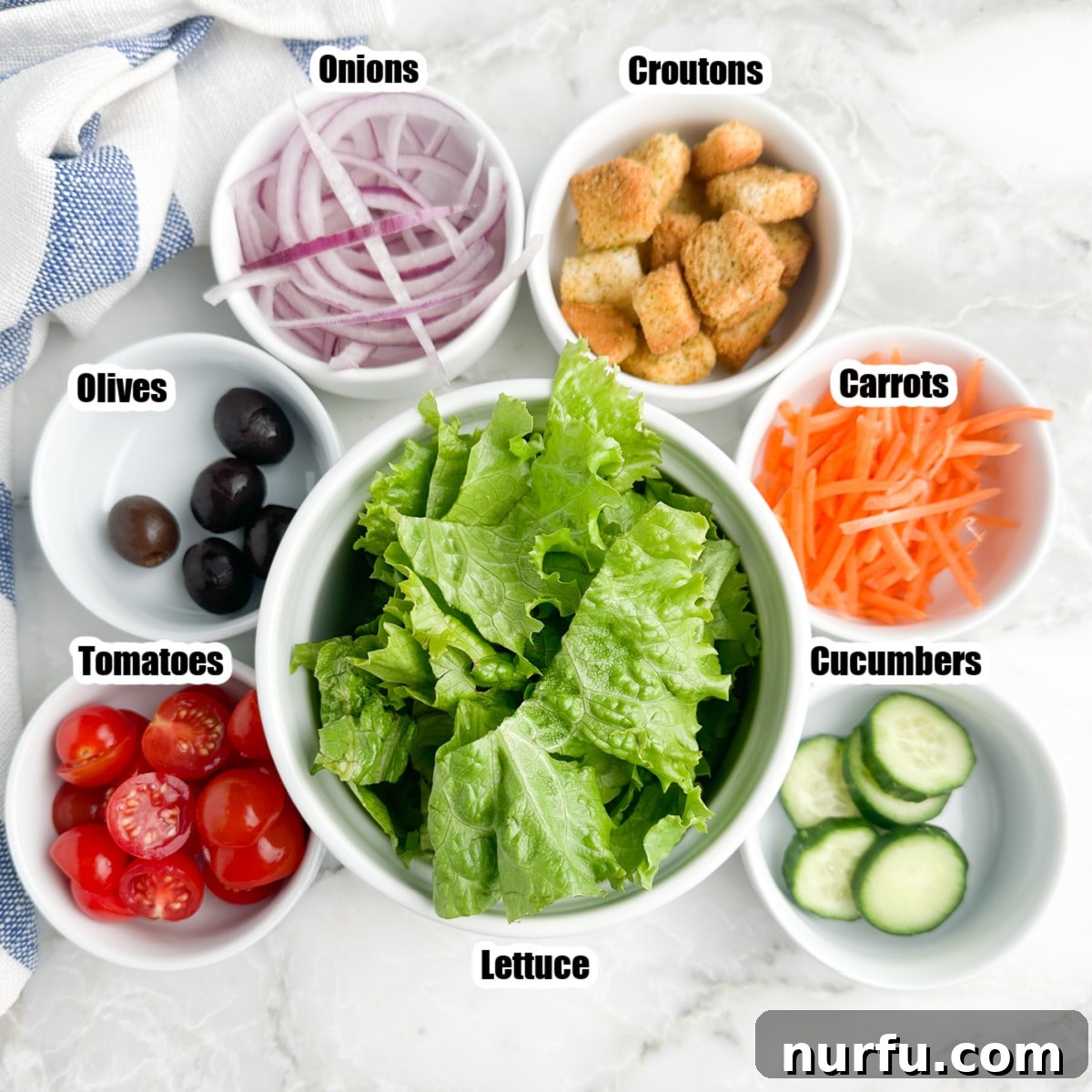 Simple House Salad Perfection 3 Bowl of lettuce, onions, croutons, carrots, cucumbers, tomatoes, and olives – the key ingredients for a house salad.