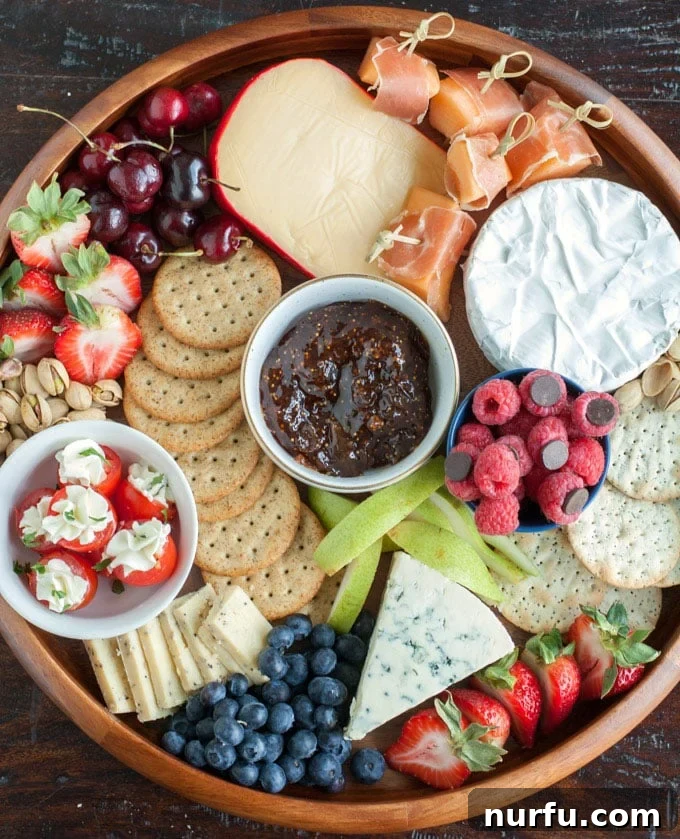 A vibrant summer cheese board overflowing with cheeses, fruits, and crackers, perfect for impressing guests.