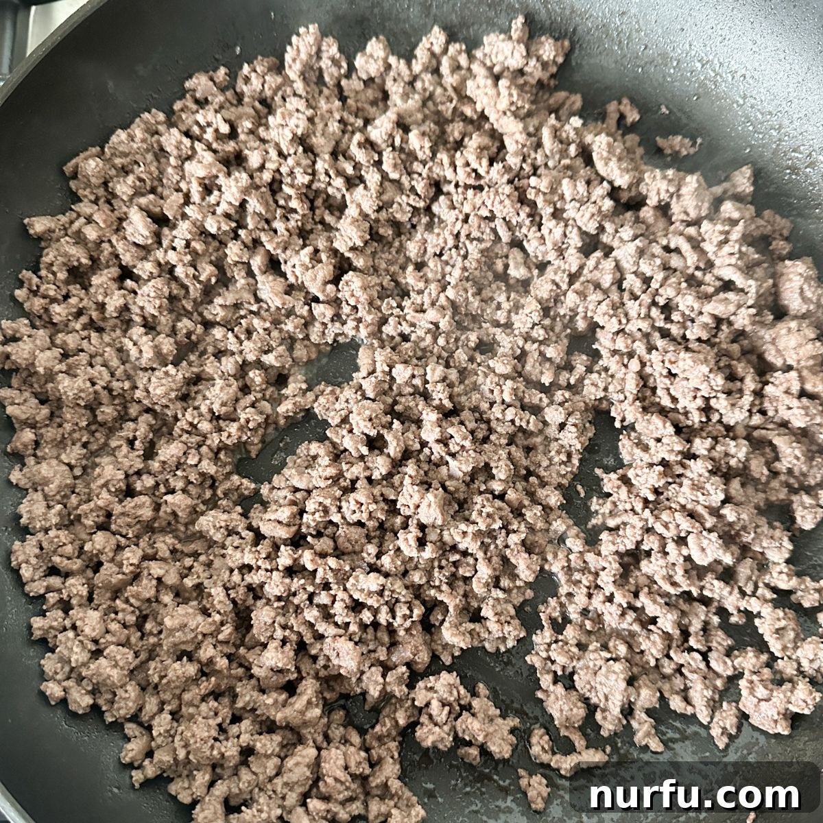Seasoning Secrets for Ground Beef 7 A skillet filled with beautifully cooked and perfectly seasoned ground beef, vibrant in color and texture, ready to be served or efficiently portioned for storage.