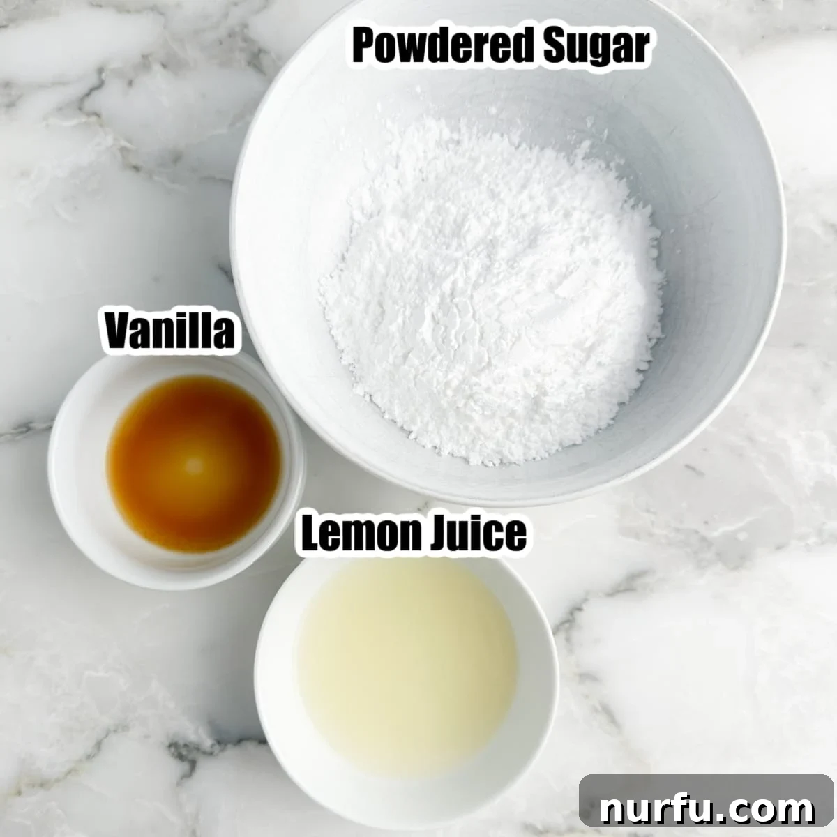 A collection of the three essential lemon glaze ingredients: powdered sugar in a bowl, vanilla extract in a measuring spoon, and fresh lemon juice in a small glass.