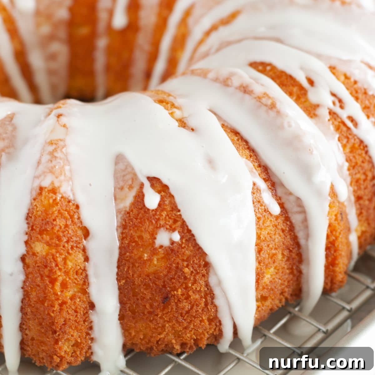A beautifully glazed Bundt cake, showcasing the perfect sheen and drip of the lemon glaze.