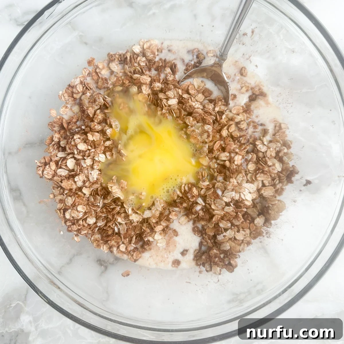 Decadent Chocolate Baked Oats 4 A bowl showing mixed oats, milk, and eggs before baking.
