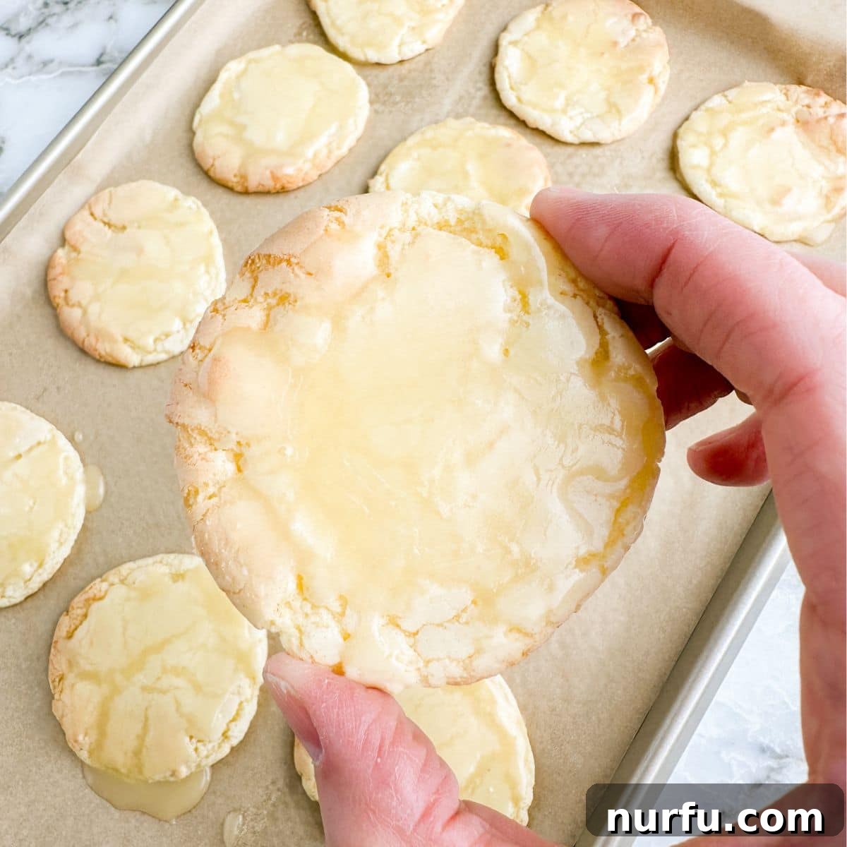 Heavenly Kentucky Butter Cake Cookies 2 Hand holding a butter cookie with icing.
