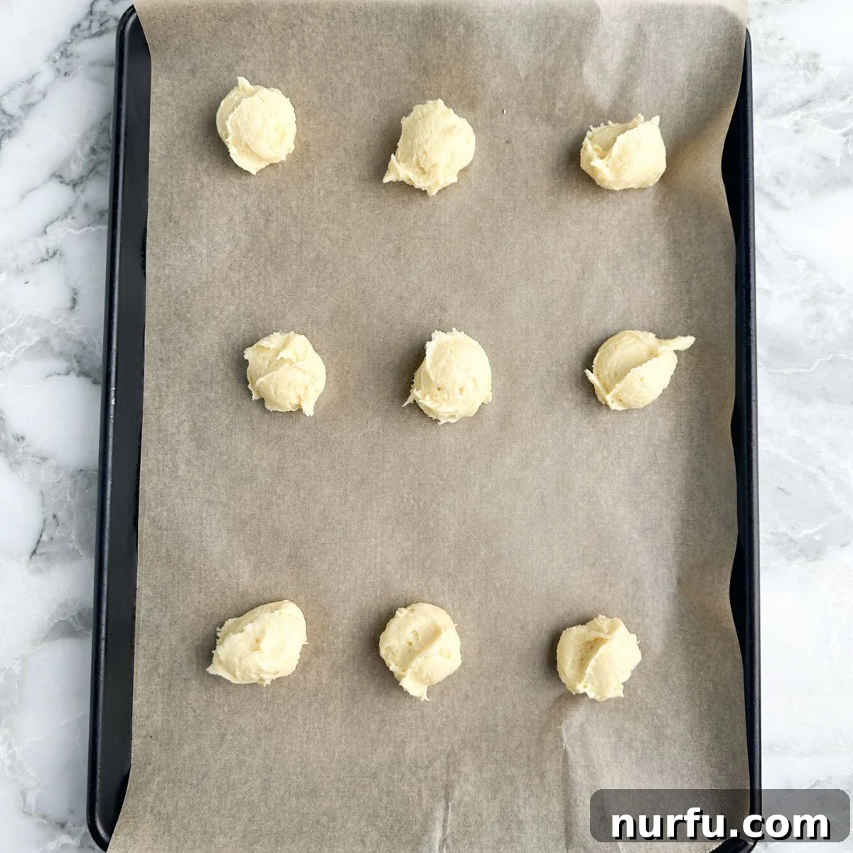 Heavenly Kentucky Butter Cake Cookies 4 Cookie dough scooped on baking sheet.