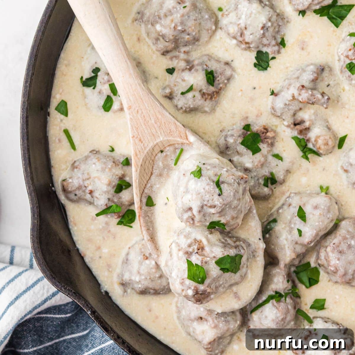 31 Effortless Friday Feasts for a Relaxing Night In 15 Cast iron skillet with meatballs in cream sauce.
