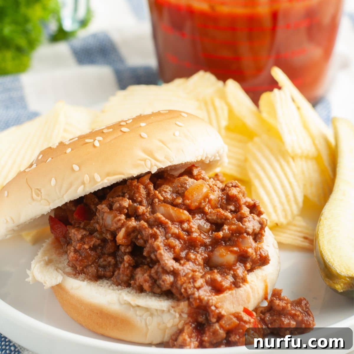 31 Effortless Friday Feasts for a Relaxing Night In 17 Sloppy joe sandwich on a plate with potato chips.