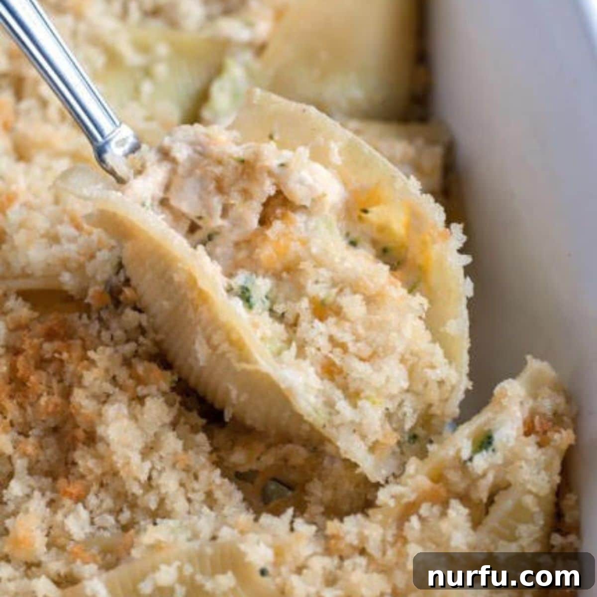 31 Effortless Friday Feasts for a Relaxing Night In 20 Spoon holding chicken stuffed shells.