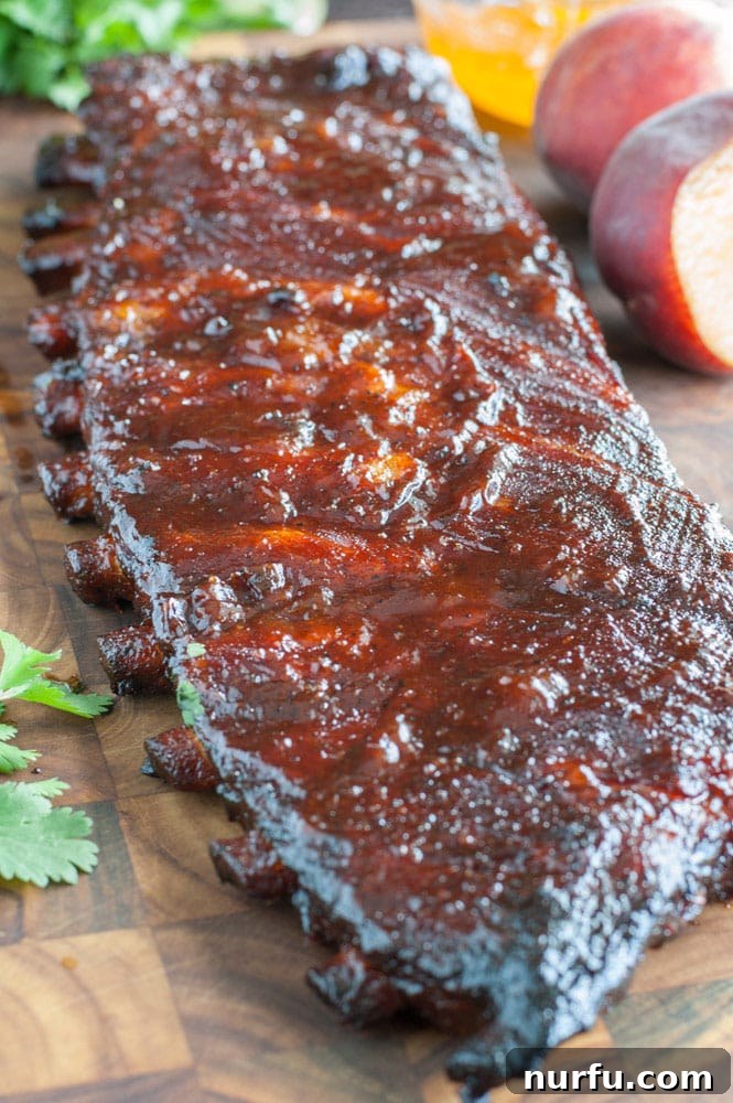 Peach Honey BBQ Ribs are tender, juicy and packed with flavor. They are easy to make so fire up the grill and get ready for some fall off the bone ribs.