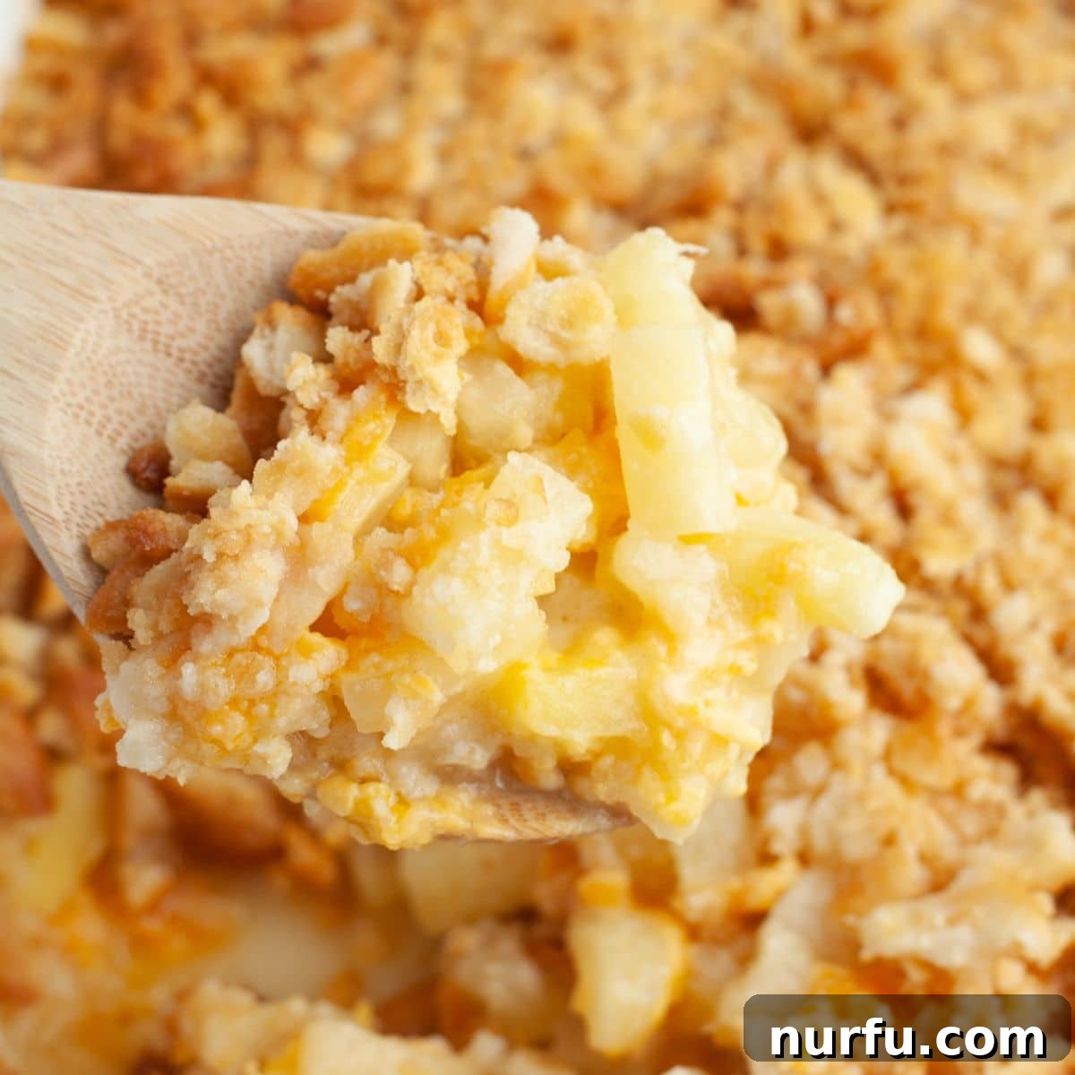 Perfect Pairings for Your Chicken Wings 19 Wooden spoon with pineapple casserole.