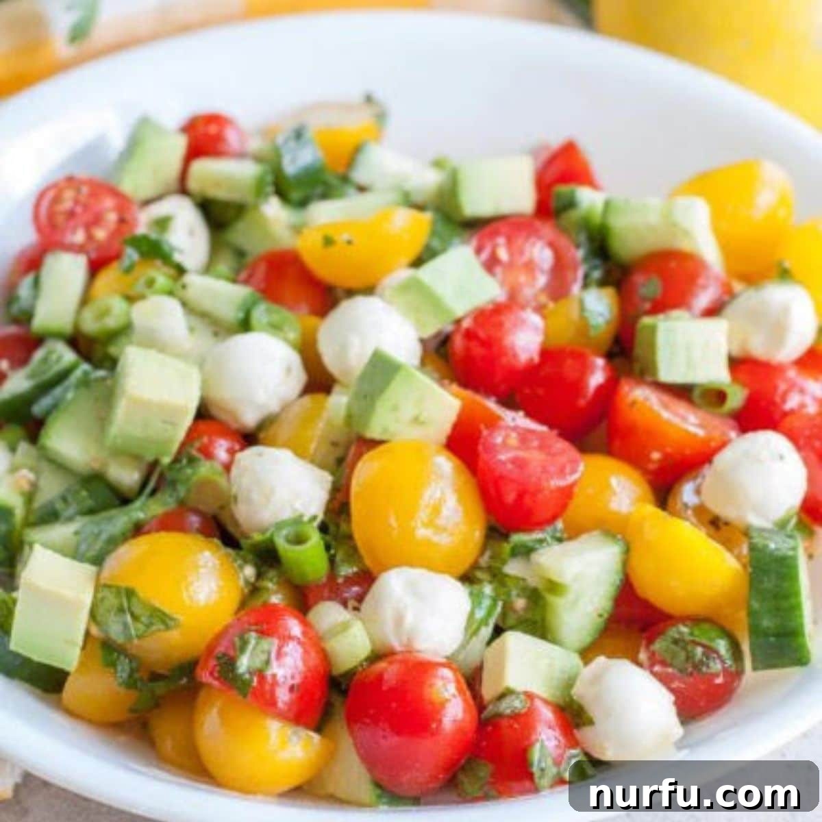 Perfect Pairings for Your Chicken Wings 33 Bowl of cucumber tomato salad with balls of mozzarella cheese.