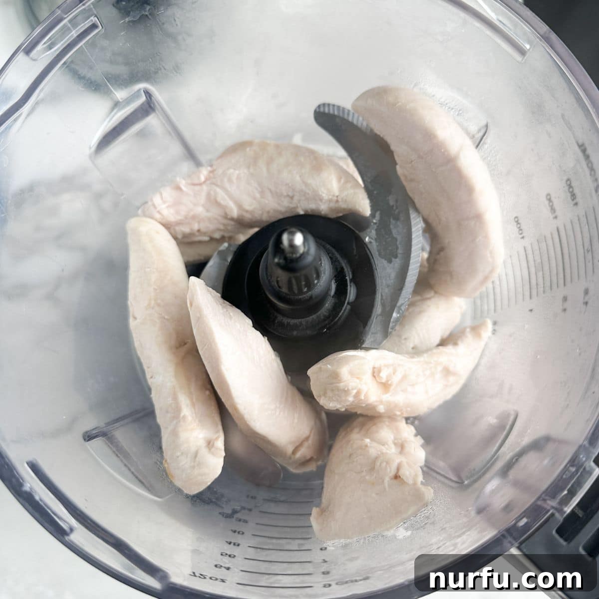 Homemade Sassy Scotty Chicken Salad 4 Cooked chicken tenderloins resting in a food processor, ready for shredding.