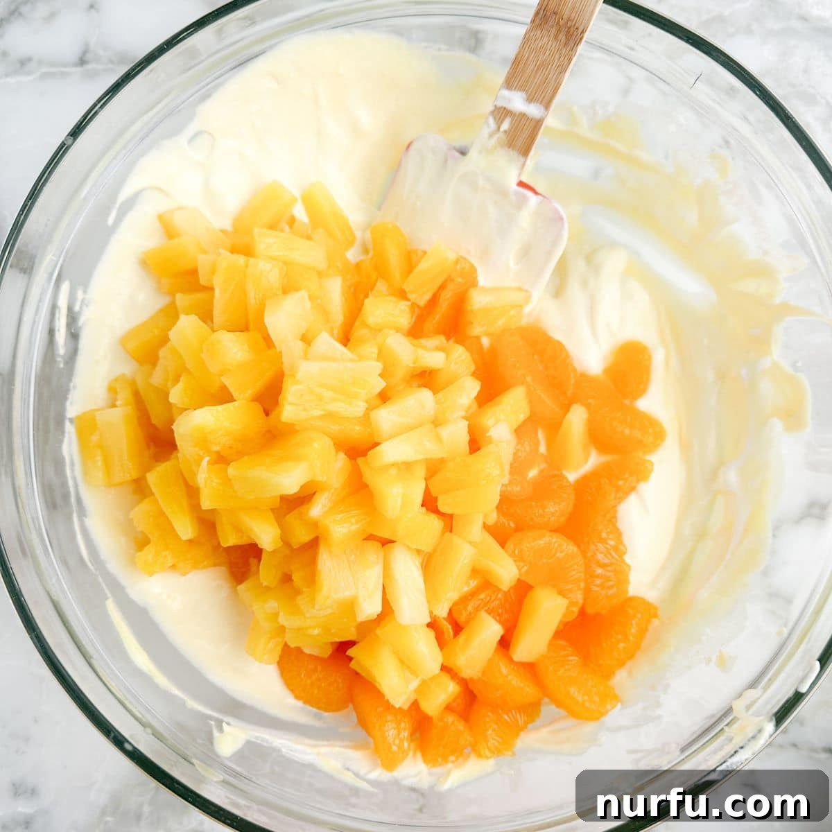 The Ultimate Cookie Salad 5 Bowl with pudding, pineapple, and mandarin oranges after mixing.