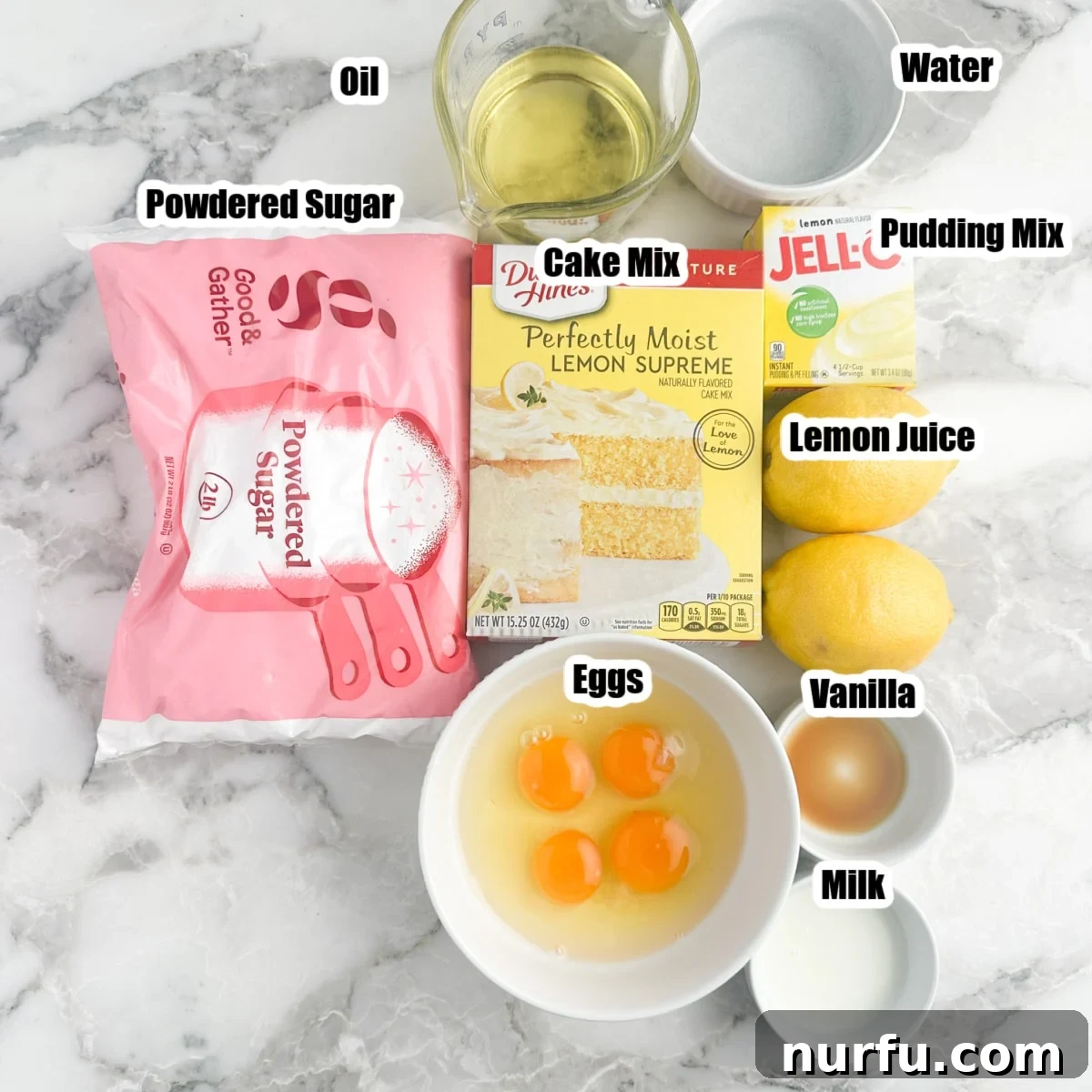 A flat lay photograph showcasing all the ingredients for lemon blossoms: powdered sugar, cake mix, pudding mix, fresh lemons, eggs, vegetable oil, and milk, arranged neatly on a surface.
