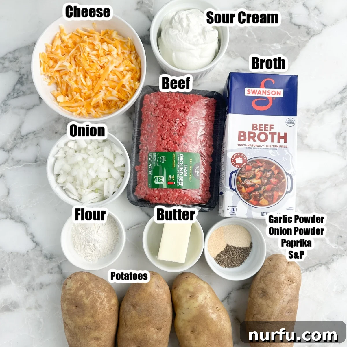 Creamy Stroganoff Potato Casserole 3 Collection of fresh ingredients for potato stroganoff: potatoes, ground beef, shredded cheese, beef broth, onions, butter, and flour.