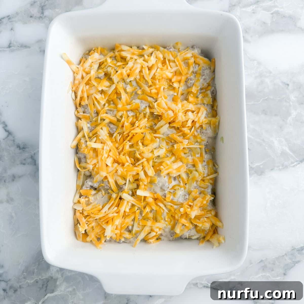 Creamy Stroganoff Potato Casserole 7 Final top layer of shredded cheese on the potato stroganoff casserole.