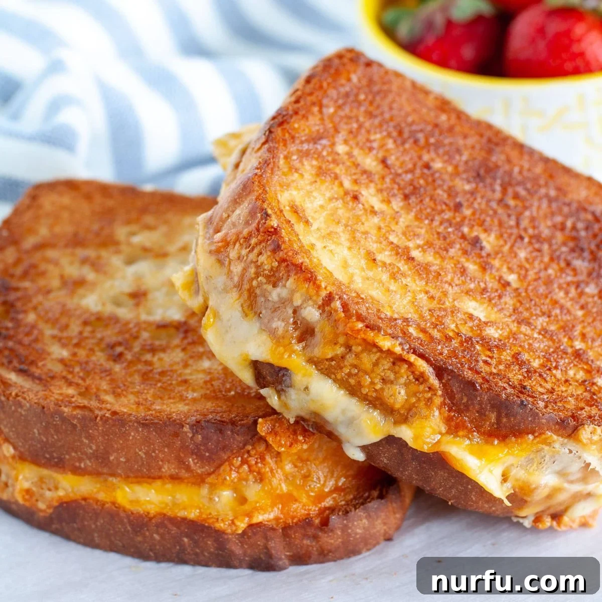 31 Perfect Side Dishes for Potato Salad 13 Two grilled cheese sandwiches on a plate.