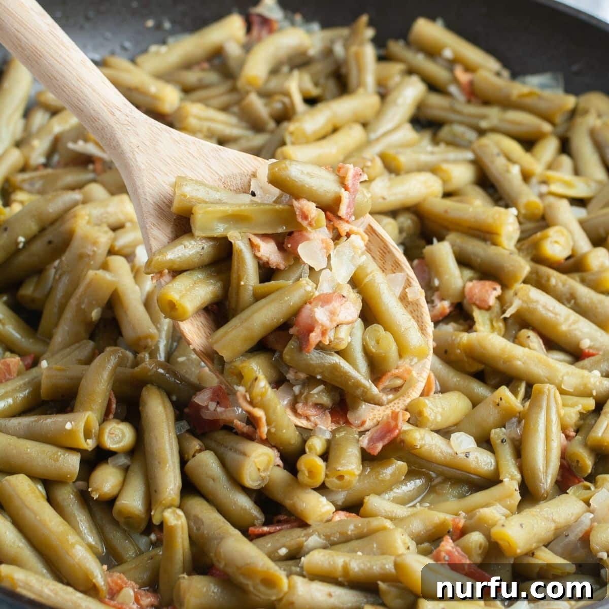 31 Perfect Side Dishes for Potato Salad 19 Skillet with green beans and bacon bits.